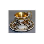 A FURSTENBERG CUP AND SAUCER with gilt handle and bands of fruiting vines. Mark in blue.