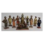 A COLLECTION OF TEN INDIAN CARVED AND PAINTED FIGURES depicting an animal god, musicians, clergy and