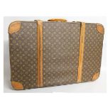 A LOUIS VUITTON SUITCASE. 30ins long, 10ins deep, 21ins wide.