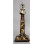 AN AGATE AND WHITE METAL MOUNTED MODEL OF A LIGHTHOUSE, the hexagonal top with canted cupola above a