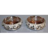 A LARGE PAIR OF PLATE CIRCULAR WINE COASTERS with fruiting vines and turned wood bases. 6ins