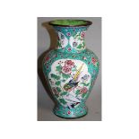 AN EARLY 20TH CENTURY CHINESE CANTON ENAMEL VASE, the sides decorated with shaped panels of birds