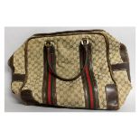 A GUCCI HOLDALL with leather handles. 20ins long, 16ins deep.