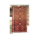 A PERSIAN DESIGN CARPET, red ground with stylised decoration. 10ft 2ins x 5ft 2ins.