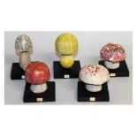 FIVE VARIOUS PAINTED WOODEN TOADSTOOLS.