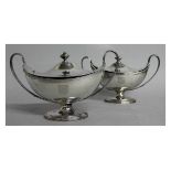 A GOOD MATCHED PAIR OF GEORGE III BOAT SHAPED TWO HANDLED PEDESTAL TUREENS AND COVERS, with reeded