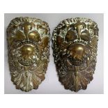 A PAIR OF LARGE BRONZE LION MASKS. 9ins.