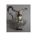 A VICTORIAN MILK JUG with repousse decoration. London 1850. Weight 9ozs.