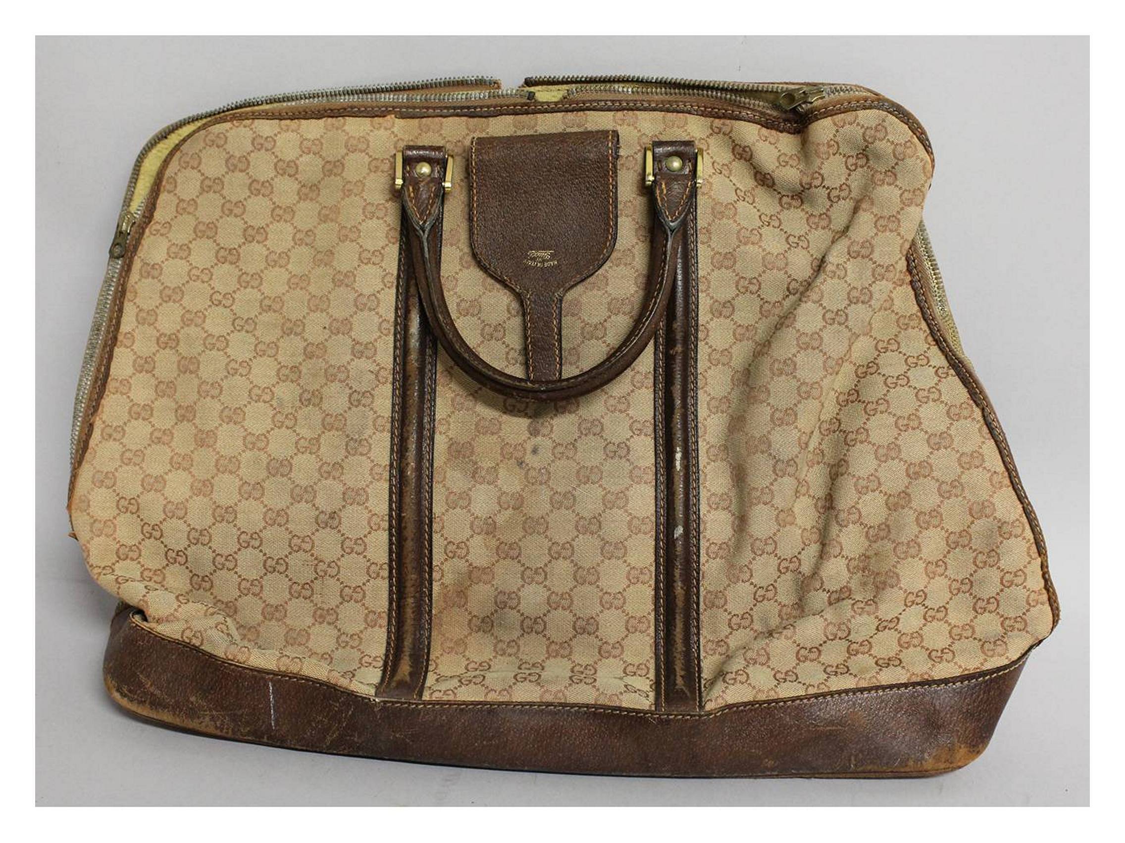 A GUCCI HOLDALL with leather handle. 22ins long, 18ins deep.