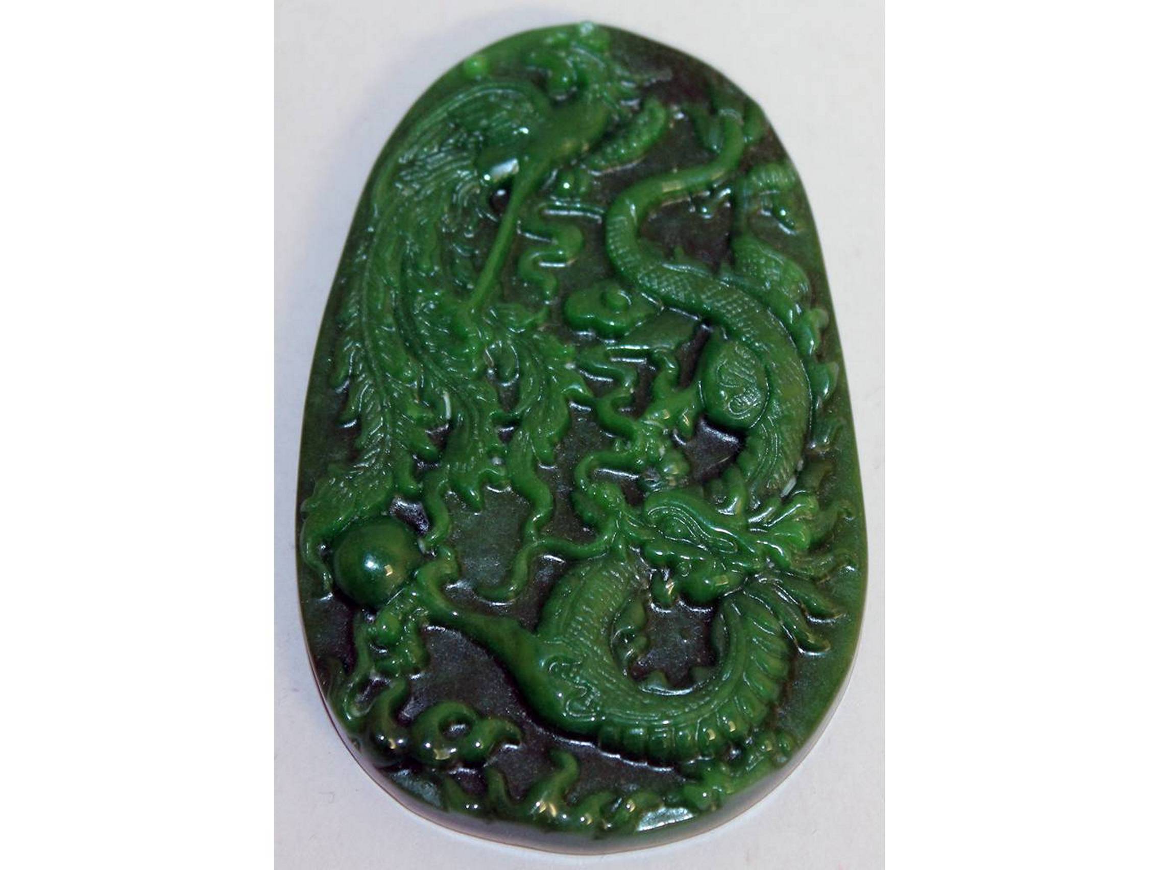 A GREEN JADE "DRAGON" PLAQUE. 3.5ins long.