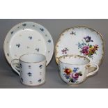 AN 18TH CENTURY VIENNA LOBED CUP AND SAUCER painted with flowers, both marked N17 in puce, a