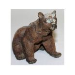 A BERGMANN PAINTED COLD CAST SEATED BEAR. 4ins high.