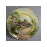 A ROYAL WORCESTER PLATE decorated with Ann Hathaway's Cottage, signed, date code for 1959.