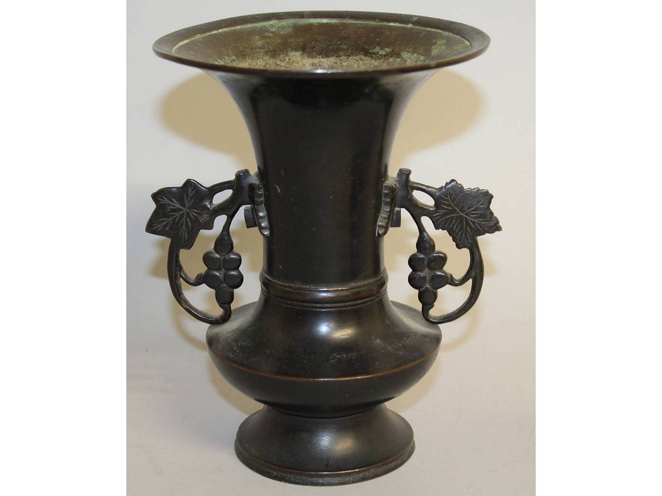 A 19TH/20TH CENTURY JAPANESE BRONZE VASE, with pierced vine handles, 6.8in high.