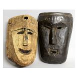 TWO CARVED WOOD TRIBAL MASKS.