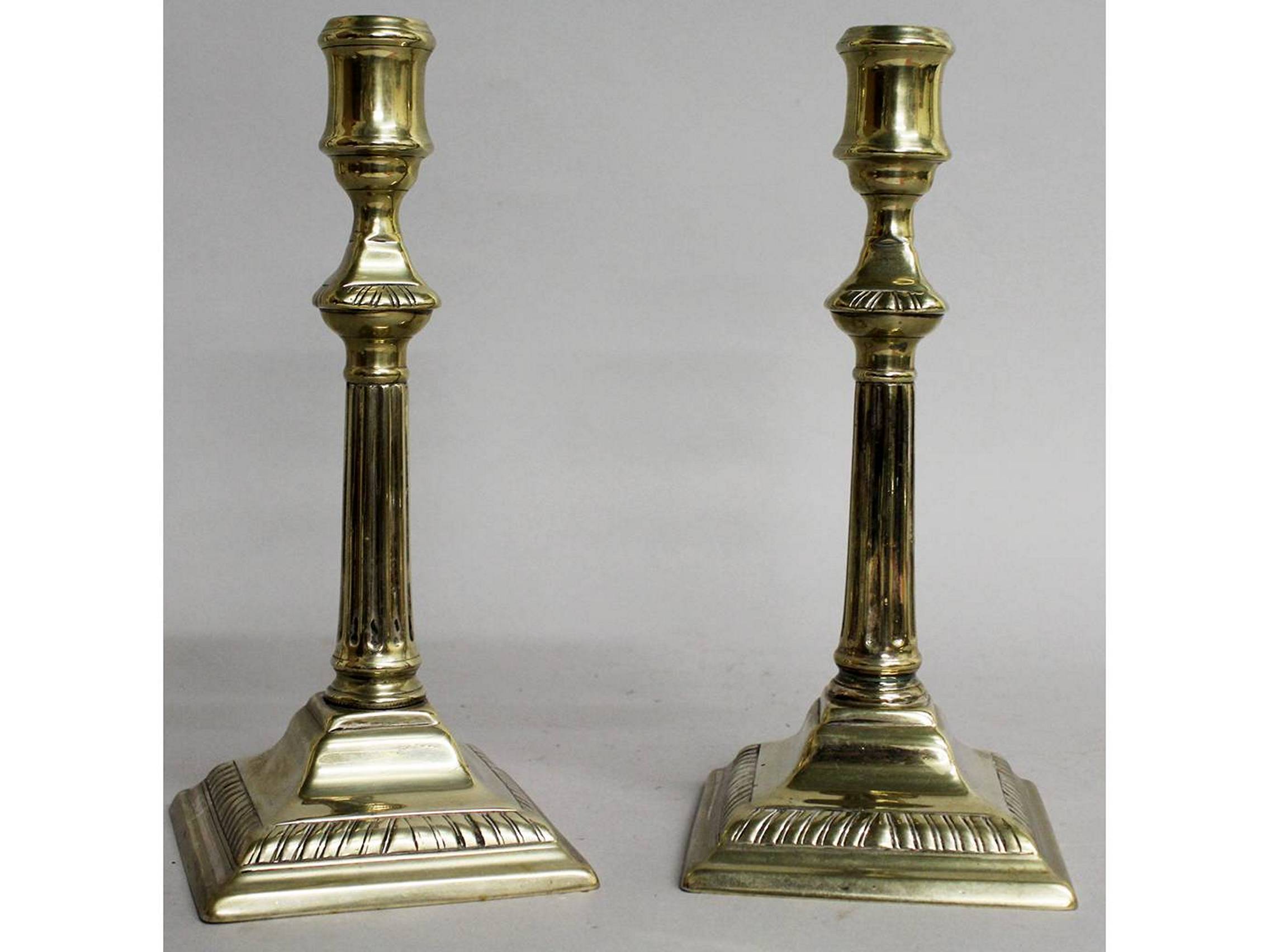 A PAIR OF GEORGE III PAKTONG CANDLESTICKS on square stepped bases. 9.5ins high.