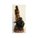 A GOOD BRONZE OF A STANDING FEMALE NUDE with an Arab. Signed, on a wooden base. 27ins high.