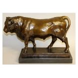 A LARGE BRONZE STANDING BULL on a marble base. 19ins long.