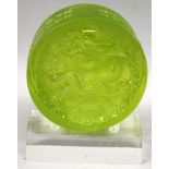 A CHINESE CIRCULAR GREEN GLASS PAPERWEIGHT, the interior moulded with a dragon, together with a