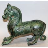 A 20TH CENTURY CHINESE PATINATED BRONZE MODEL OF A MYTHICAL ANIMAL, 9.5in long & 8.3in high.