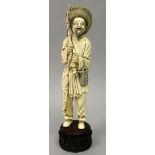 AN EARLY 20TH CENTURY CHINESE IVORY FIGURE OF A FISHERMAN, together with a fixed wood stand, the man