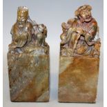 A PAIR OF 19TH/20TH CHINESE SOAPSTONE SEALS, each carved with a reclining Immortal seated on an