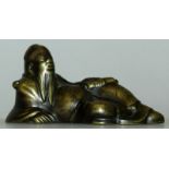 A 17TH CENTURY CHINESE BRONZE WATERDROPPER, cast in the form of a reclining sage, 3.75in wide & 1.