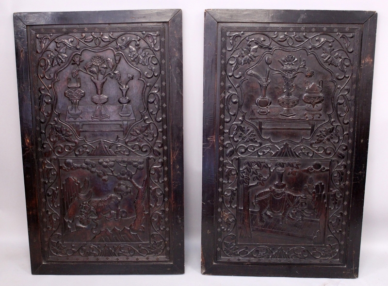 A LARGE PAIR OF 19TH CENTURY CHINESE CARVED HARDWOOD PANELS, each decorated with bronze-form