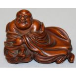 A SMALLER GOOD QUALITY 19TH CENTURY CARVED HARDWOOD FIGURE OF BUDAI, reclining and leaning on his