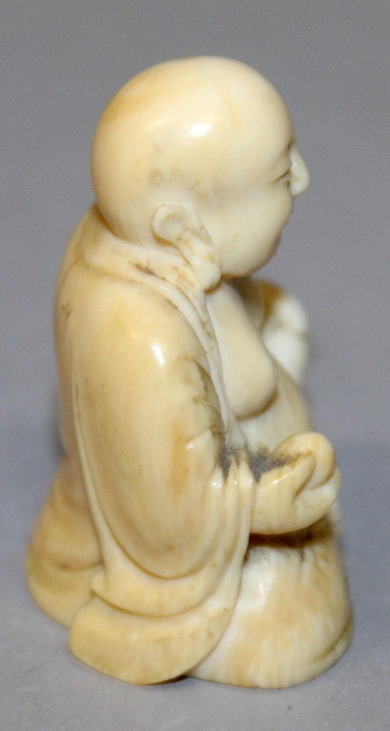 A SMALL 19TH CENTURY CHINESE CARVED IVORY FIGURE OF BUDAI, seated with cheerful expression, 1.75in - Image 2 of 6