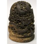 A CHINESE BROWN STAINED CARVING, possibly stained ivory, carved in deep relief with a sinuous dragon