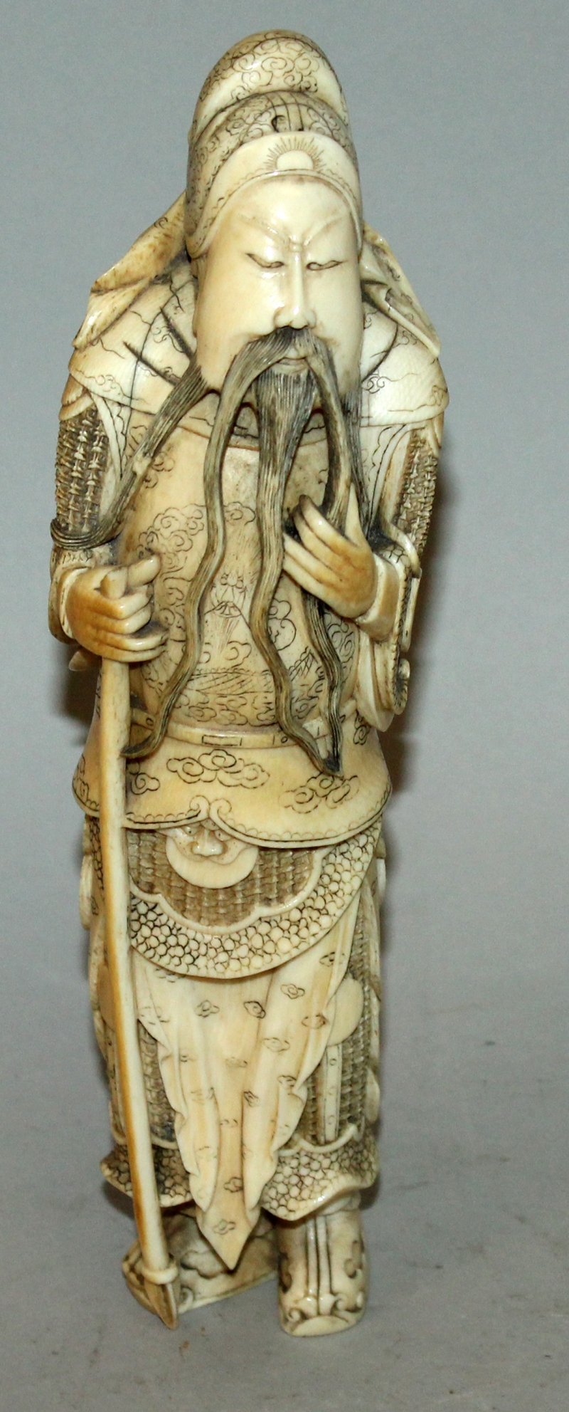 A GOOD 19TH/20TH CENTURY CHINESE CARVED IVORY FIGURE OF GUANDI, holding a long spear, his