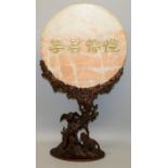 A LARGE UNUSUAL 20TH CENTURY CHINESE PINK MARBLE TABLE SCREEN ON AN ELABORATE CARVED WOOD STAND, the