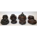 A GOOD GROUP OF TEN 19TH CENTURY CHINESE CARVED HARDWOOD STANDS & A VASE COVER, mainly of good