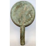 AN ORIENTAL BRONZE HAND MIRROR, with extensive patination and traces of a rectangular seal mark, 4.