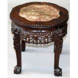 A 19TH CENTURY CHINESE MARBLE TOP CARVED HARDWOOD STAND, with shaped top, vine and leaf frieze and