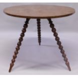 A GOOD BURR ELM CIRCULAR "CRICKET" STYLE TABLE with three bobbin turned legs.