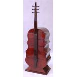 AN UNUSUAL ART DECO STYLE ROSEWOOD CHEST OF DRAWERS, modelled as a cello, with four small drawers.