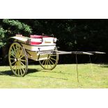 A LATE 19TH CENTURY GOVERNESS CART, with a pair of large wooden spoked wheels, with rubber tyres,