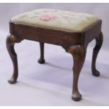 A GOOD GEORGE I WALNUT STOOL with drop-in needlework seat, supported on cabriole legs.