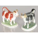 TWO STAFFORDSHIRE COW CREAMERS.