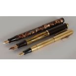 THREE OLD PENS with gold nibs.