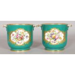 A GOOD PAIR OF SEVRES CIRCULAR CACHE POTS, the body sage green and painted with two panels of