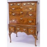 AN EARLY 18TH CENTURY WALNUT CHEST ON STAND, the upper section with a veneered and crossbanded