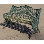 A GOOD GREEN PAINTED CAST IRON GARDEN BENCH of naturalistic form.