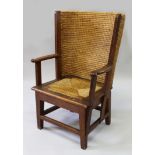 A GOOD CHILD'S ORKNEY CHAIR, of typical form, with oak frame and drop-in rush seat on stretchered