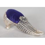 A NOVELTY SILVER SHOE PIN CUSHION.