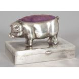 A NOVELTY SILVER PIG PIN CUSHION.