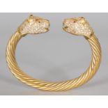 A SUPERB HALLMARKED SILVER GILT BANGLE set with crystals in the form of two leopard's heads.