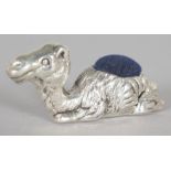 A NOVELTY SILVER CAMEL PIN CUSHION.